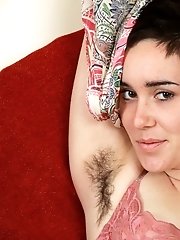 Barb tickles her hairy clit on the chair